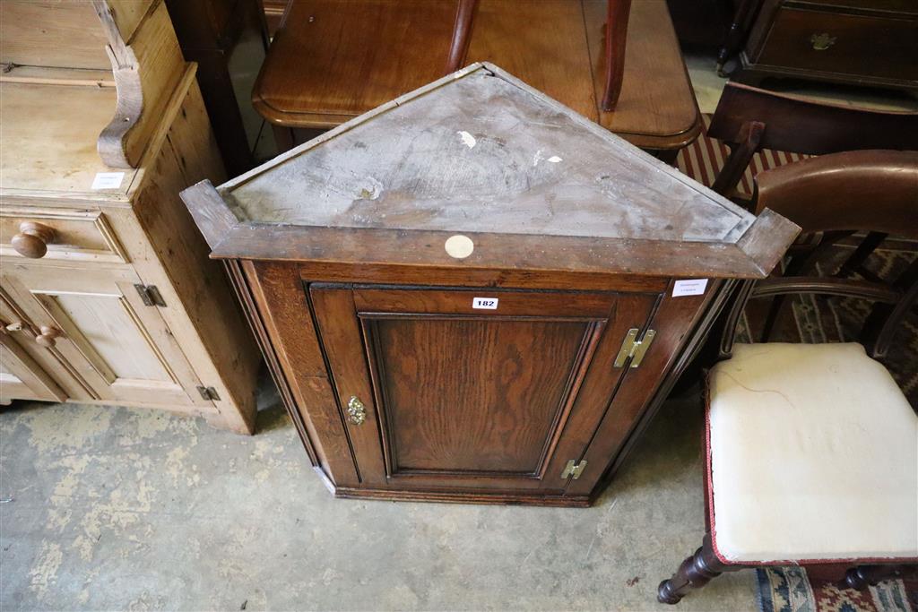 A George III oak hanging corner cabinet, width 74cm, depth 42cm, height 92cm